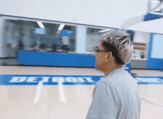 A Man Stands On A Basketball Court With The Word Detroit On It GIF