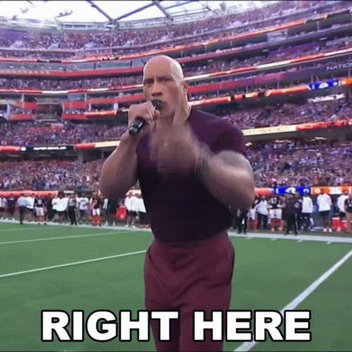 A Man Stands On A Football Field Holding A Microphone With The Words Right Here Above Him GIF