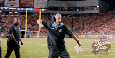 A Man Stands On A Football Field With A Double Fries Logo In The Background GIF