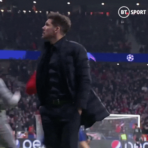 A Man Stands On A Soccer Field In Front Of A Bt Sport Banner GIF