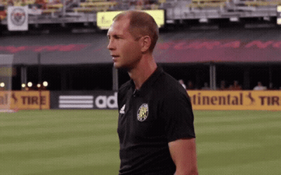 A Man Stands On A Soccer Field In Front Of A Continental Tire Sign GIF