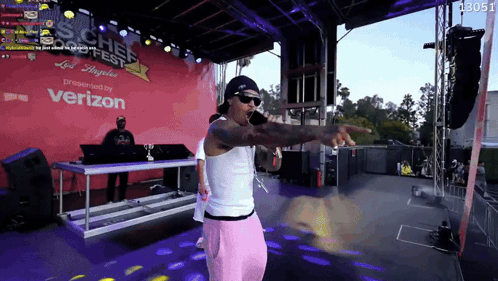 A Man Stands On A Stage In Front Of A Sign That Says ' Verizon ' GIF