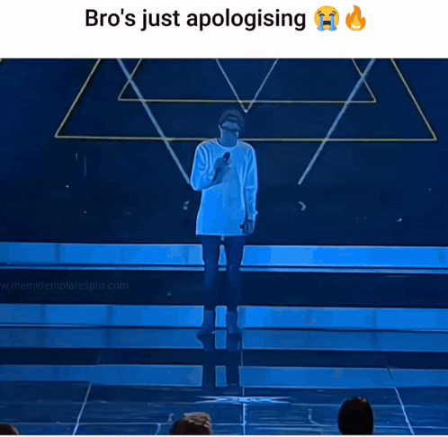 A Man Stands On A Stage With A Microphone And Says Bro 'S Just Apologizing GIF