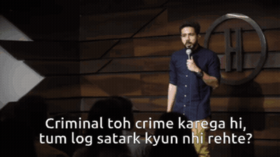 a man stands on a stage with a microphone and says criminal toh crime kanega hi tum log satark kyun nhi rehe