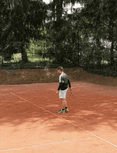 A Man Stands On A Tennis Court Holding A Tennis Racket GIF