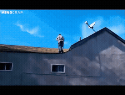 A Man Stands On The Roof Of A Building With A Satellite Dish On Top Of It GIF