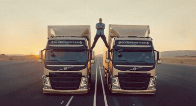 A Man Stands On The Roof Of A Volvo Truck GIF