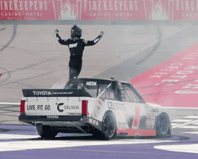 A Man Stands On Top Of A Race Car That Says Celsius GIF
