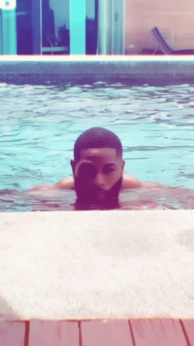 A Man Swimming In A Pool With His Eyes Closed GIF