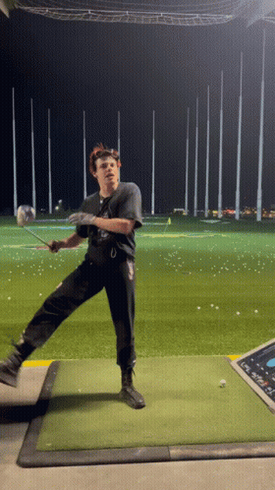 A Man Swings A Golf Club On A Golf Course GIF