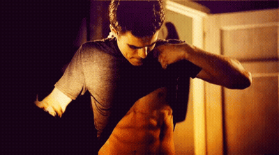 A Man Takes Off His Shirt To Show Off His Muscles GIF