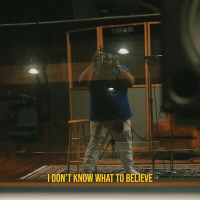 A Man Taking A Picture In Front Of A Stark & Luke Recording Studio GIF