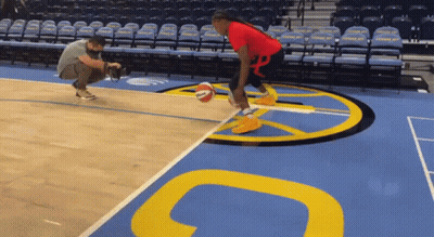 A Man Taking A Picture Of A Basketball Player On A Court GIF