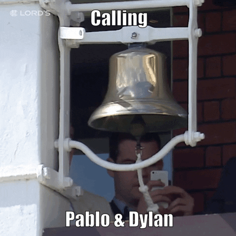 A Man Taking A Picture Of A Bell With The Words Calling Pablo & Dylan On It GIF