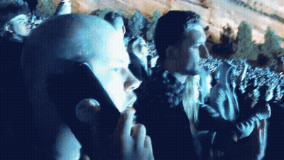 A Man Taking A Picture Of A Crowd With A Cellphone GIF