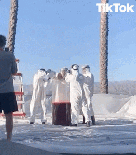 A Man Taking A Picture Of A Group Of People With The Word Tik Tok On The Bottom Right GIF