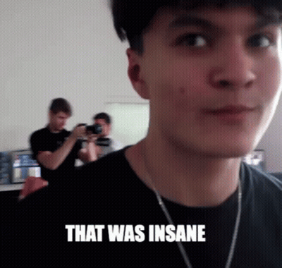 A Man Taking A Picture Of Another Man With The Words That Was Insane Above Him GIF