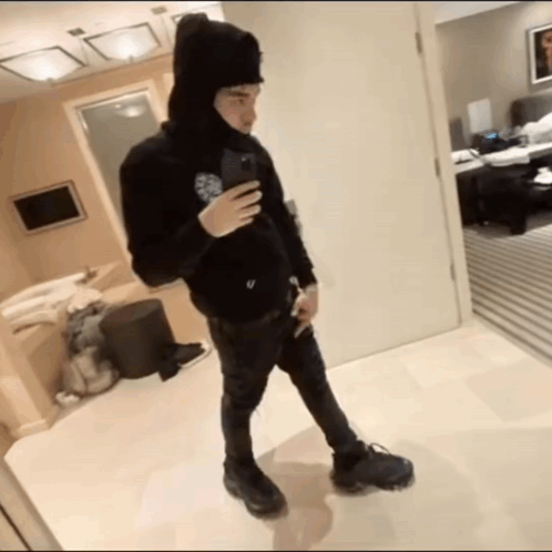 A Man Taking A Picture Of Himself In A Bathroom GIF