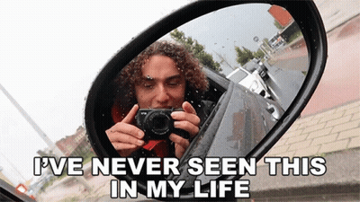 A Man Taking A Picture Of Himself In A Car Mirror With The Caption " I Ve Never Seen This In My Life " GIF