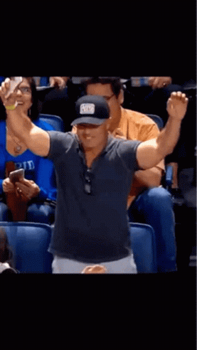 A Man Taking A Picture Of Himself In A Stadium With A Hat That Says ' A ' On It GIF