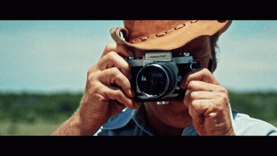 A Man Taking A Picture With A Nikkormat 1 Camera GIF