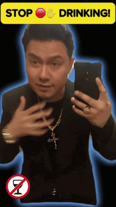 A Man Taking A Selfie With A Stop Drinking Sign GIF