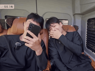 A Man Taking A Selfie With Another Man Covering His Face GIF