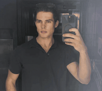 A Man Taking A Selfie With His Phone In A Dark Room GIF