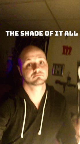 A Man Taking A Selfie With The Words " The Shade Of It All " On The Bottom GIF