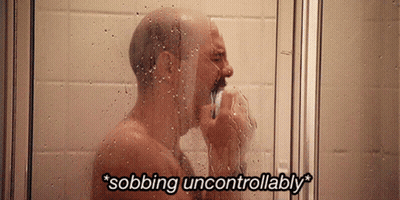 A Man Taking A Shower With The Words " Sobbing Uncontrollably " Written Above Him GIF