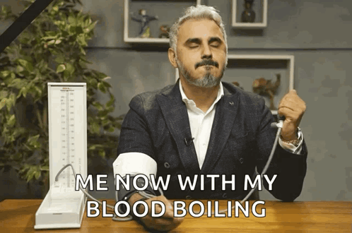 A Man Taking His Blood Pressure With The Words Me Now With My Blood Boiling Above Him GIF