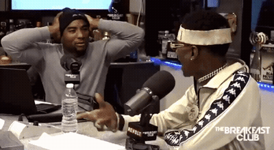 A Man Talking Into A Microphone With The Breakfast Club Written On The Side GIF