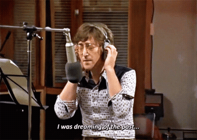 A Man Talking Into A Microphone With The Words " I Was Dreaming Of The Past " Below Him GIF