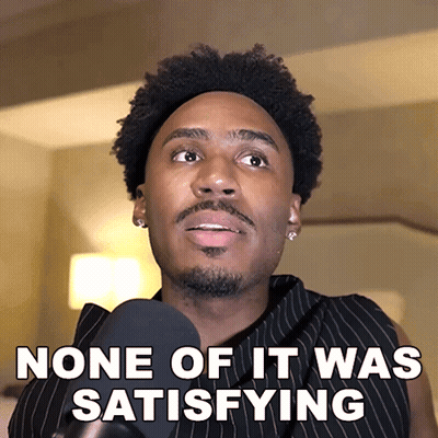 A Man Talking Into A Microphone With The Words None Of It Was Satisfying Below Him GIF