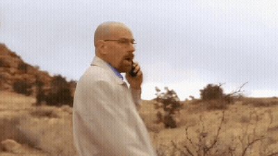 A Man Talking On A Cell Phone While Walking In The Desert GIF