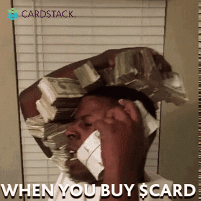 A Man Talking On A Cell Phone With A Stack Of Money On His Head GIF