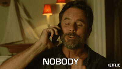 A Man Talking On A Cell Phone With The Word Nobody Written Below Him GIF