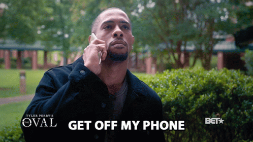 A Man Talking On A Cell Phone With The Words " Get Off My Phone " Above Him GIF