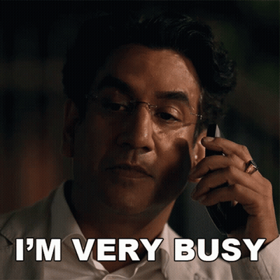 A Man Talking On A Cell Phone With The Words " I 'M Very Busy " Next To Him GIF