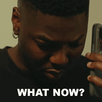 A Man Talking On A Cell Phone With The Words " What Now " Written Below Him GIF