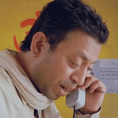 A Man Talking On A Phone With A Sign Behind Him That Says " If You Want To We Have Design " GIF