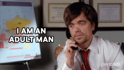 A Man Talking On A Phone With The Words I Am An Adult Man Behind Him GIF