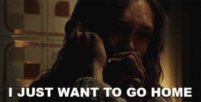 A Man Talking On A Phone With The Words " I Just Want To Go Home " Behind Him GIF