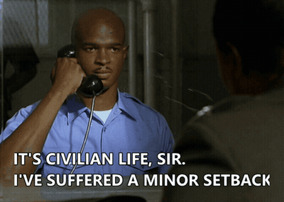A Man Talking On A Phone With The Words " It 'S Civilian Life Sir I 'Ve Suffered A Minor Setback " GIF