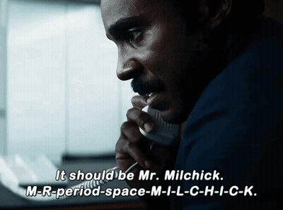 A Man Talking On A Phone With The Words " It Should Be Mr. Milchick " On The Bottom GIF