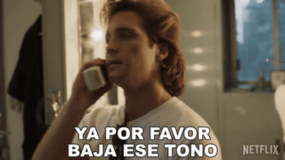 A Man Talking On A Phone With The Words Ya Por Favor Baja Ese Tono GIF