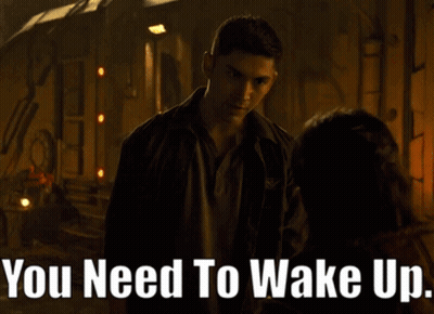 A Man Talking To A Woman With The Words " You Need To Wake Up " On The Bottom GIF