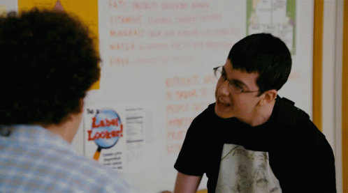 A Man Talking To Another Man In Front Of A White Board With A Label Locker On It GIF
