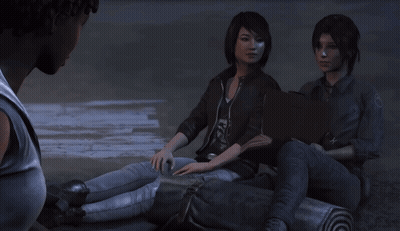 A Man Talks To Two Girls Sitting On A Log GIF