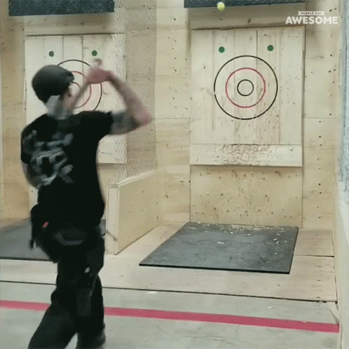 A Man Throws An Axe At A Target That Says Awesome On The Bottom GIF